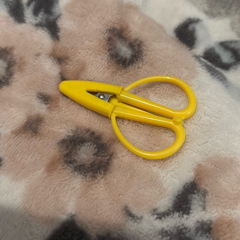 Tiny yellow craft scissors with safety cover
